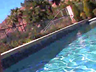Asa Akira lays out by her pool and gets oiled up